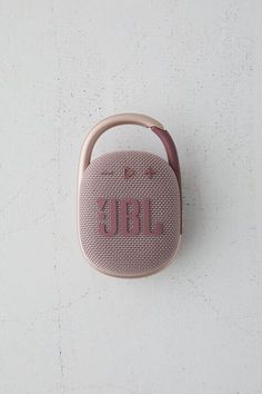 the jbl portable bluetooth speaker is shown on a white surface with a pink handle