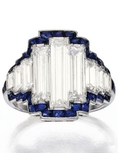 Platinum, Diamond and Sapphire Ring. Set with nine baguette diamonds weighing approximately 2.40 carats, bordered by French-cut sapphires, partially numbered; circa 1925. #ArtDeco #ring Diamond And Sapphire Ring, Art Deco Ring, Sapphire Jewelry