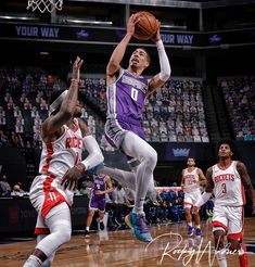 an image of a basketball game going on in the air with one player trying to block the ball