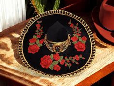 Discover the beauty and tradition of our handcrafted women's Charro sombreros, made with authentic Mexican craftsmanship. Each sombrero is meticulously designed, featuring intricate details that celebrate the rich heritage of Charro culture. Made from high-quality materials, these sombreros offer both style and durability. With a one-size-fits-all design, they provide a comfortable and perfect fit for any occasion, whether it's a cultural event or a stylish day out. Embrace the elegance and timeless charm of Mexican tradition with our exquisite Charro sombreros. Mexican Hats For Women, Mariachi Hats, Traditional Wide Brim Hat For Cinco De Mayo, Mexican Sombrero, Brimmed Black Hats And Headpieces For Western-themed Events, Red Charro Hat, Charro Saddle, Mariachi Hat, Mexican Sombrero Hat