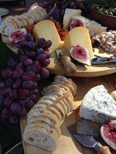 an assortment of cheeses and meats on wooden platters