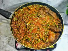 a pan filled with food sitting on top of a stove