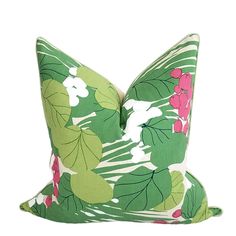 a green pillow with pink flowers on it