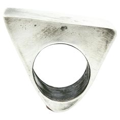 Sterling Silver ‘Triangle’ Ring This piece was created when I was walking through NYC, where I live and work, and I noticed garden with a trellis that sloped up and looked like a triangle. It hit me that I could create a hollow triangle, one of simplicity but also statement making. Creating hollow forms are basically by bending and shaping the precious metal into the shape you want. Then, you solder that piece, standing up on a base, or bottom piece. I will post a video soon so that you can get Soldered Rings, Rings Inspiration, Sculptural Ring, Architectural Jewelry, Hollow Ring, Simple Projects, Hollow Form, Ville New York, Triangle Ring