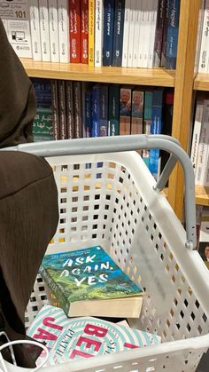 a book in a basket next to some books