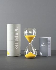 an hourglass with yellow sand sitting next to it