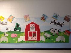 a bulletin board with farm animals and pictures on the wall in front of it,