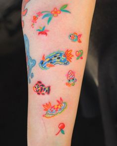 a person with colorful tattoos on their arm