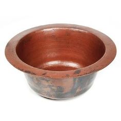 a brown bowl sitting on top of a white table