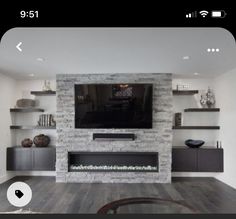 a living room with a fireplace and entertainment center