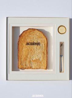 a piece of bread in a box with the word acuremus written on it