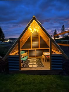 a small wooden house sitting on top of a lush green field