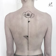 a woman with a flower tattoo on her back