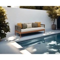 a couch sitting next to a swimming pool