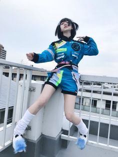 a woman is posing on top of a building