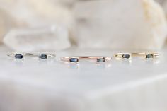 three different types of rings sitting on top of a white marble table next to each other