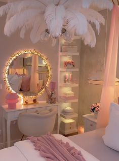 a bedroom decorated in pink and white with lights on the ceiling, mirror, bed, desk and chair