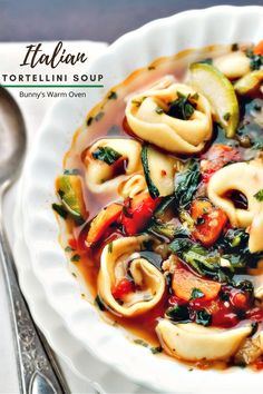 a white bowl filled with tortelli soup on top of a table