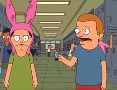 a man and woman with pink bunny ears talking to each other in front of lockers