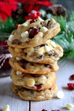 a stack of cookies with white chocolate chips and cranberries