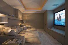 a living room filled with furniture and a flat screen tv mounted to the side of a wall