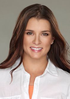 a woman with long brown hair wearing a white shirt and an orange belt around her waist