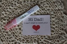 a white toothbrush sitting on top of a piece of paper next to a pink marker