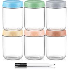 four glass jars with lids and one pen