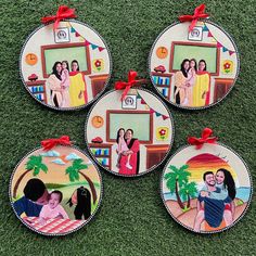 four personalized christmas ornament hanging on the grass in front of a tv