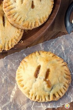 two small pies sitting on top of wax paper