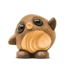 a wooden toy with eyes and nose on it's head, sitting in front of a white background