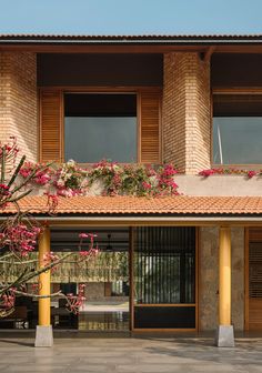 an outside view of a building with flowers on the balcony