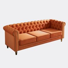 This Chesterfield sofa features gold stripe trim and deep button tufting to add a classic glamour style to your living room. Made from a solid wood frame, with elastic webbing and bending springs, the entire structure is strong. The cushion is made of high density sponge for maximum comfort. The compressed foam takes 3 to 4 days to spring back, and once it does, it is ready for normal use. House of Hampton® Fabric: Orange Velvet | House of Hampton® Angelys 84.65" Velvet Sofa 30.31 H x 84.65 W x Velvet Chesterfield Sofa, Classic Glamour, Hampton House, Living Room Orange, Living Ro, Double Sofas, Glamour Style, Modern Couch, Orange House