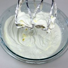 a bowl filled with whipped cream on top of a table