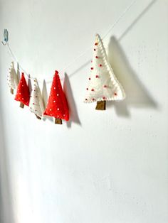 three felt christmas trees hanging on a string