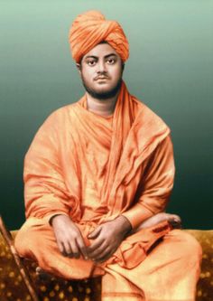 a man in an orange turban sitting down