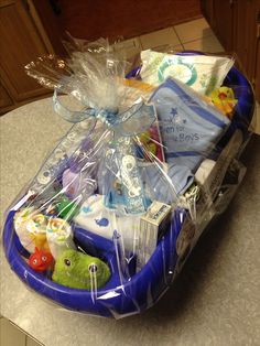 a blue basket filled with baby items on top of a counter