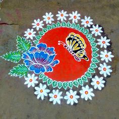 a colorful painting on the ground with white flowers and a yellow butterfly sitting on it