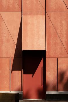 an orange building with a red door on the side