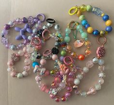 many different colored beads and charms on a table