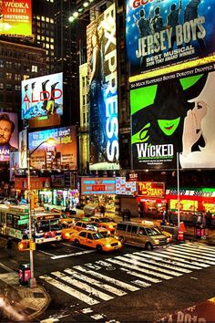 a busy city street filled with lots of traffic and tall buildings covered in neon signs