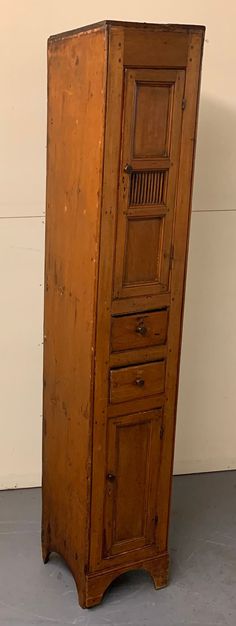 an old wooden cabinet with three drawers on one side and two doors on the other