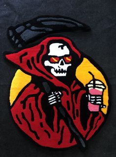 a patch with a skeleton holding a drink in it's hand and wearing a red robe