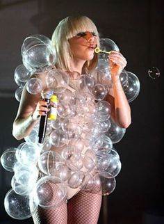 a woman in fishnet stockings blowing bubbles