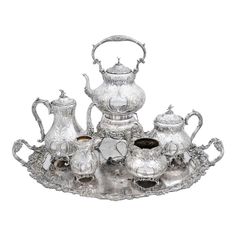 an ornate silver tea set on a tray