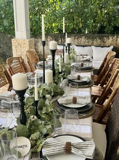 a table set with place settings and candles