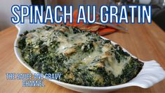 spinach and gravy casserole in a white dish on a wooden table