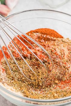 a glass bowl filled with spices and seasoning