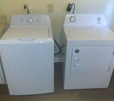 two washers and dryer sitting next to each other