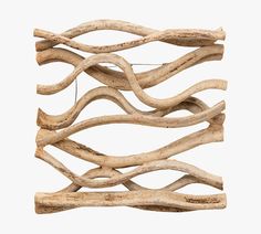 driftwood sticks are stacked together on top of each other to form a wall decoration